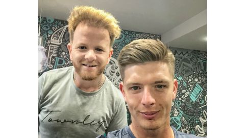 Burnley fan, Simon Townley, cutting Burnley and England goalkeeper Nick Pope's hair.