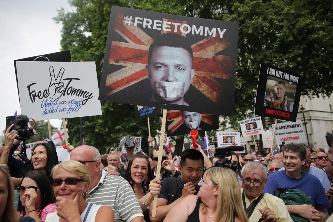Protesters hold up placards at a gathering by supporters of far-right figure Tommy Robinson in central London on June 9, 2018.