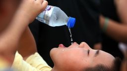 A young boy drinks icy water to get cool during a 2006 summer heatwave in Beijing. 