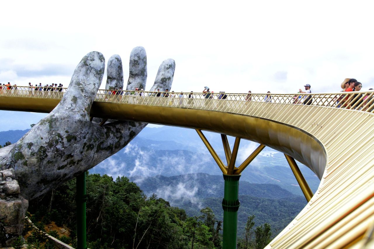 Visitors walk along the 150-meter long Cau Vang "Golden Bridge" in the Ba Na Hills near Danang.