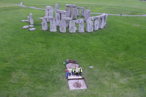 Researchers stand at the excavation site of Aubrey Hole 7, where cremated human remains were recovered at Stonehenge to be studied. New research suggests that 40% of 25 individuals buried at Stonehenge weren't from there -- but they possibly transported stones from west Wales and helped build it.  