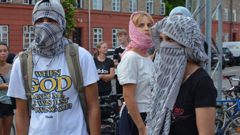 Demonstrators wear face veils to protest Denmark's burqa ban. 