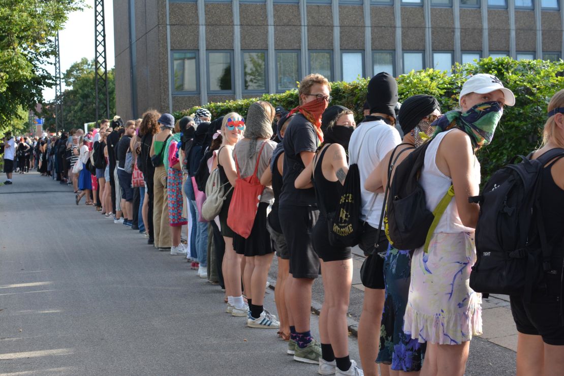 Protesters form a human chain around a police station.