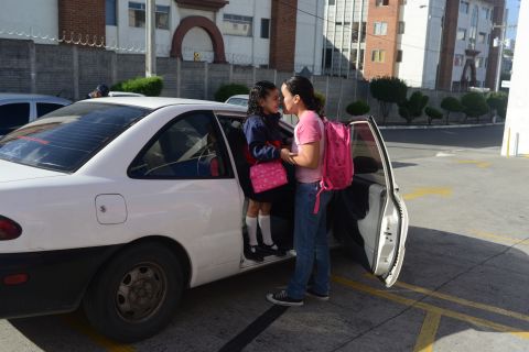 Margarita Samayoa drops off her 6-year-old daughter, Valentina Rodas, in Guatemala City, Guatemala.