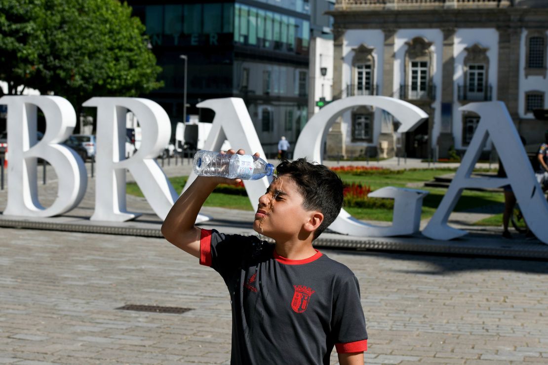 A child pours water over himself in Braga, northern Portugal, on Wednesday.