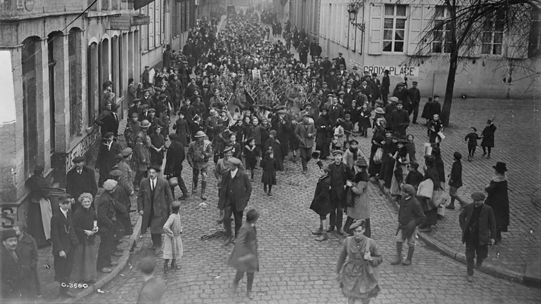 Canadians marching through the streets of Mons on the morning of November 11, 1918. 