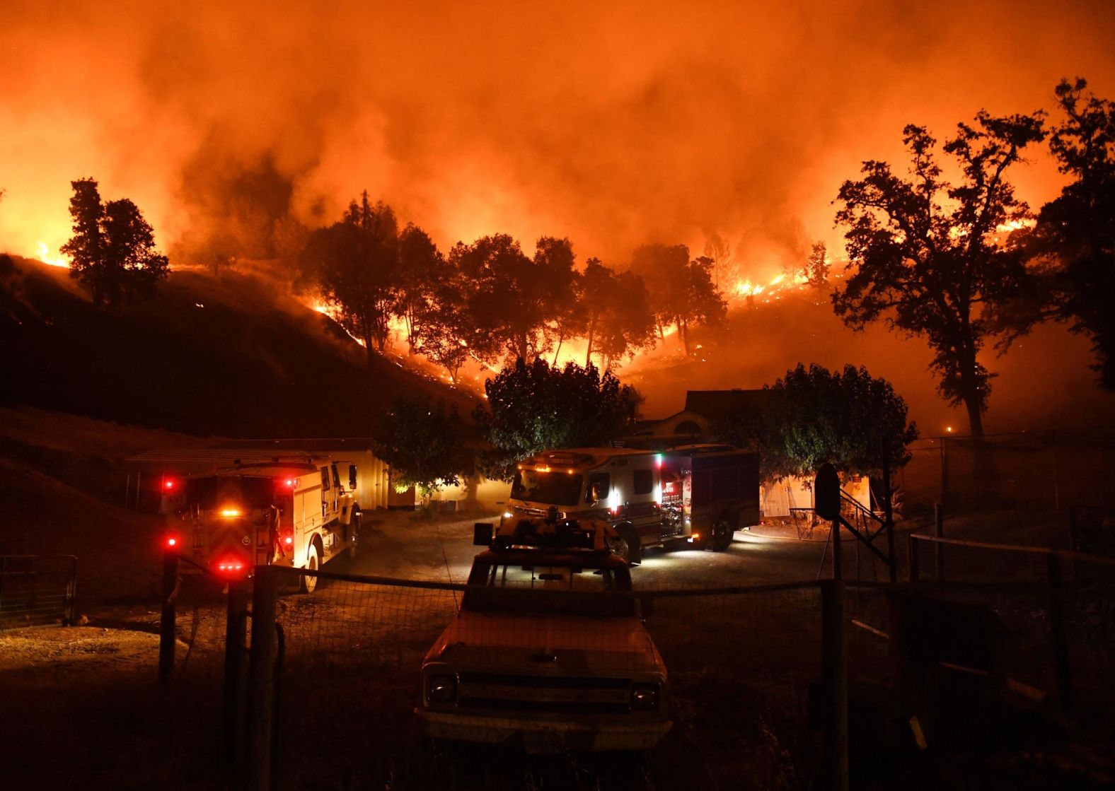 Firefighters conduct a controlled burn to defend houses from the Ranch Fire as it moves toward Upper Lake.