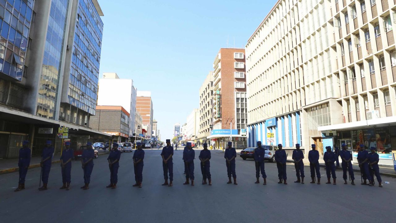 Police block a road leading to the opposition offices Thursday in Harare.