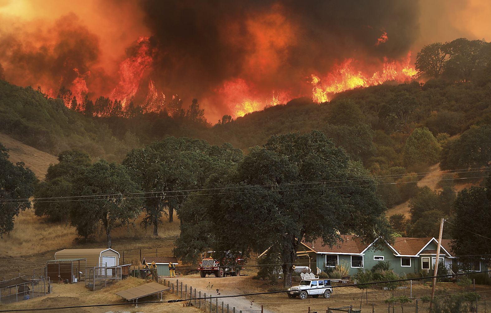 Flames from a wildfire advance down a hillside near Lakeport on August 2.