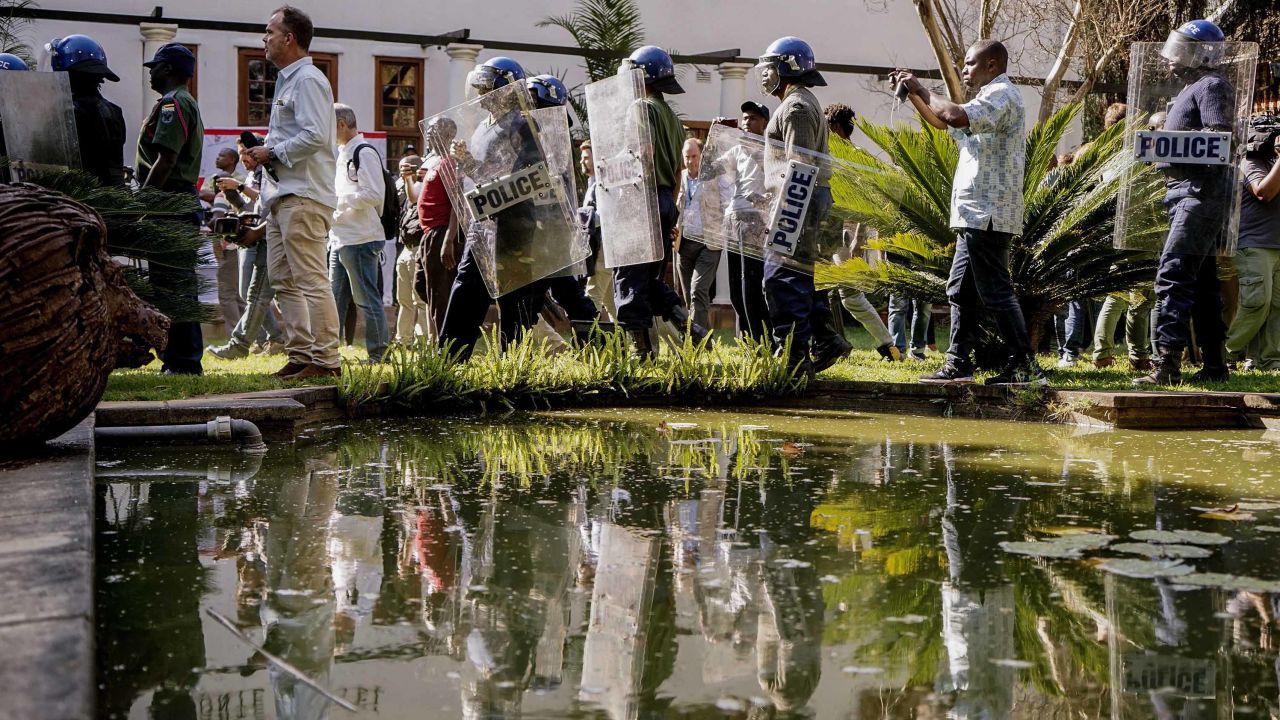 Zimbabwe anti-riot police personnel deploy Friday at the Bronte Hotel in Harare.