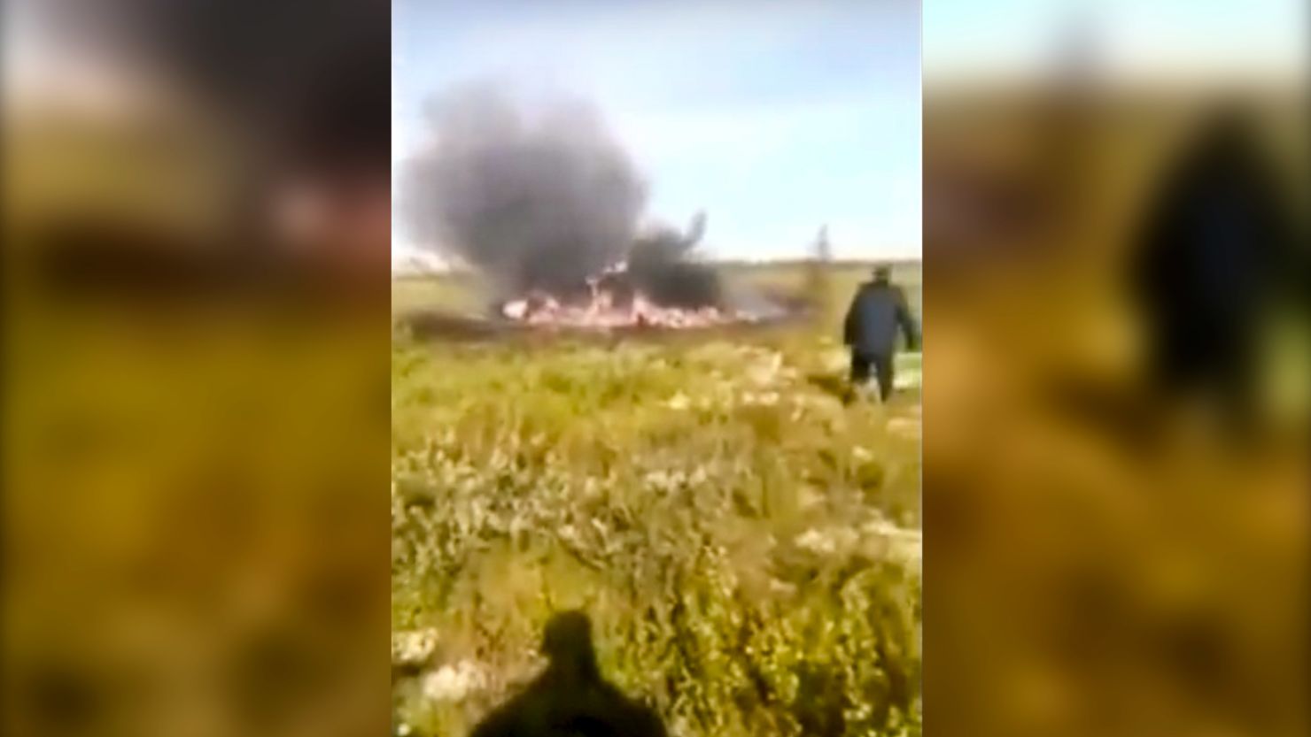 Smoke rises Saturday from the helicopter crash site in this still image from a Russian Emergency Situations Ministry video.