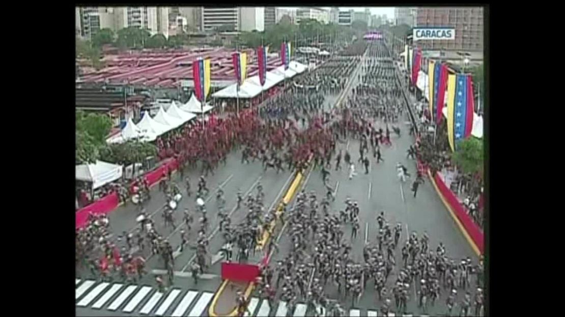 The crowd at the parade in Caracas disperses after what officials called an attack on the President.