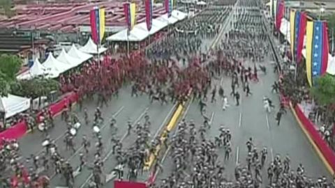 The crowd at the parade in Caracas disperses after what officials called an attack on the President.