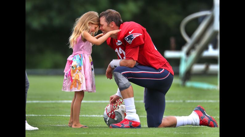 New England Patriots quarterback Tom Brady spends some time with his daughter, Vivian, 5, after Patriots training camp at the practice facility in Foxborough, Massachusetts on Wednesday, August 1. 