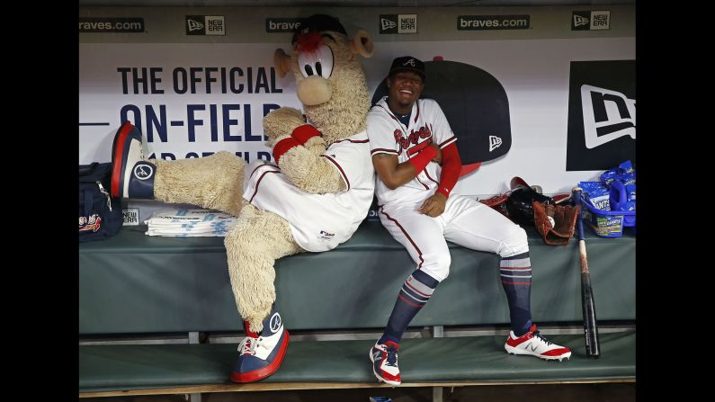 Atlanta Braves mascot Blooper and left fielder Ronald Acuna Jr. play around in the dugout during a rain delay before the game against the Miami Marlins on Tuesday, July 31, in Atlanta, Georgia.  