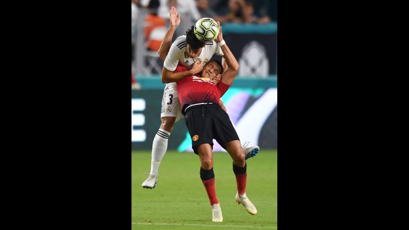 Jesús Vallejo of Real Madrid pulls down Alexis Sanchez of Manchester United during a header attempt in the first half of International Champions Cup action in Miami Gardens, Florida on Tuesday, July 31. 