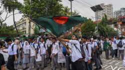 A Bangladeshi student wave Bangladesh's national flag as they block a road during a student protest in Dhaka on August 4, 2018, following the deaths of two college students in a road accident . - Parts of the Bangladeshi capital ground to a halt for the seventh day running on August 4, as thousands of students staged protests calling for improvements to road safety after two teenagers were killed by a speeding bus. (Photo by MUNIR UZ ZAMAN / AFP)        (Photo credit should read MUNIR UZ ZAMAN/AFP/Getty Images)