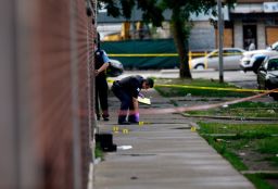 Officers investigate a shooting in Chicago on Sunday.