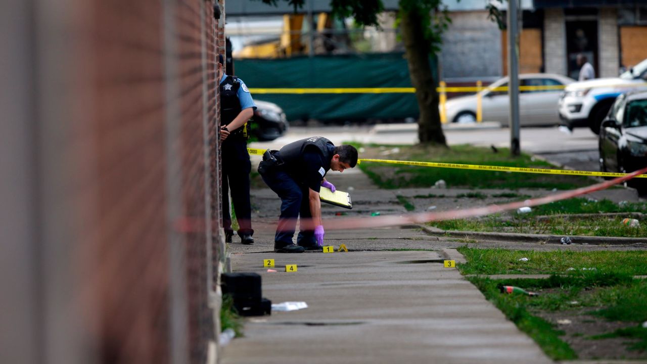 Officers investigate a shooting in Chicago on Sunday.