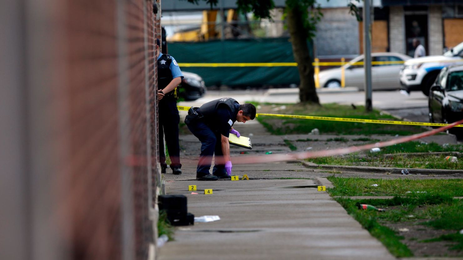 Chicago police investigate a crime scene where multiple people were shot on Sunday, August 5, 2018.  (Photo by Joshua Lott/Getty Images)
