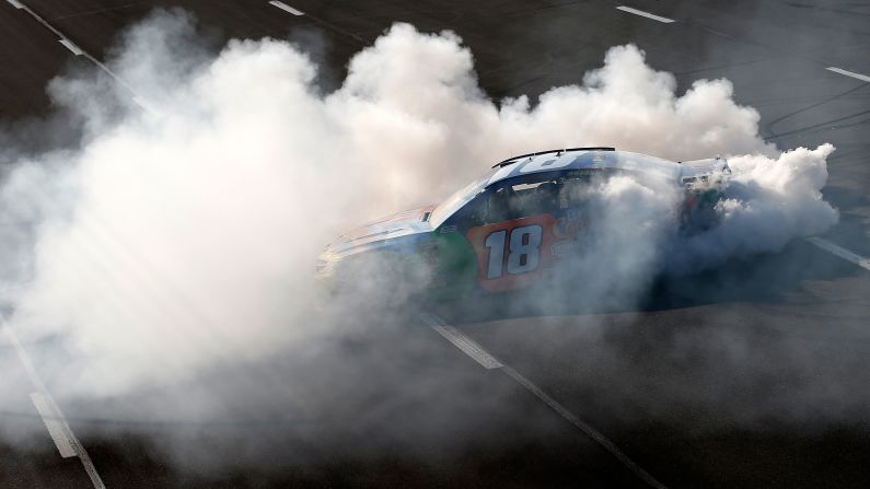 Kyle Busch celebrates with a burnout after winning the Monster Energy NASCAR Cup Series Gander Outdoors 400 at Pocono Raceway on Sunday, July 29, in Long Pond, Pennsylvania.  