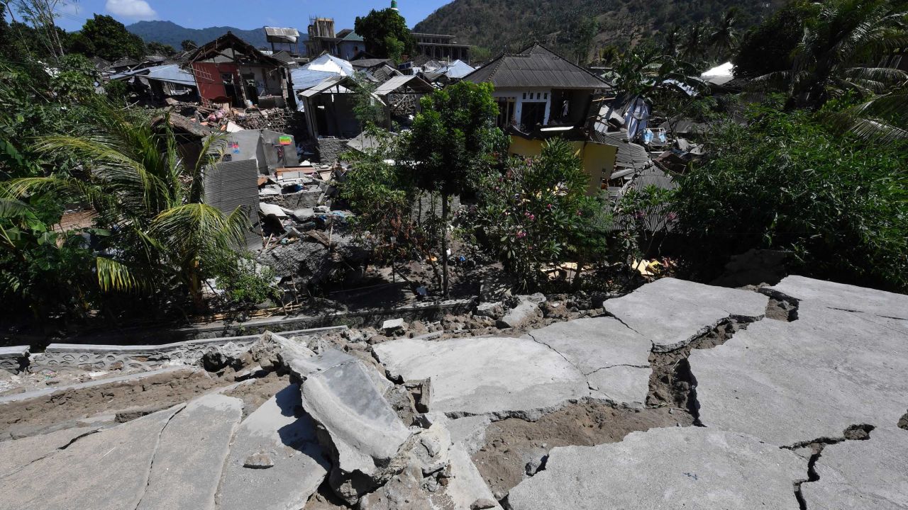 Cracked concrete and damaged houses are pictured in Pemenang,  northern Lombok.