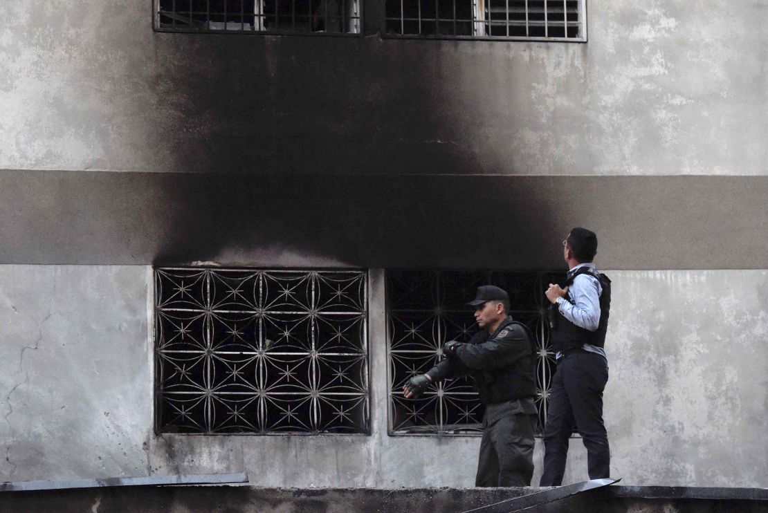 Security forces check a nearby building.