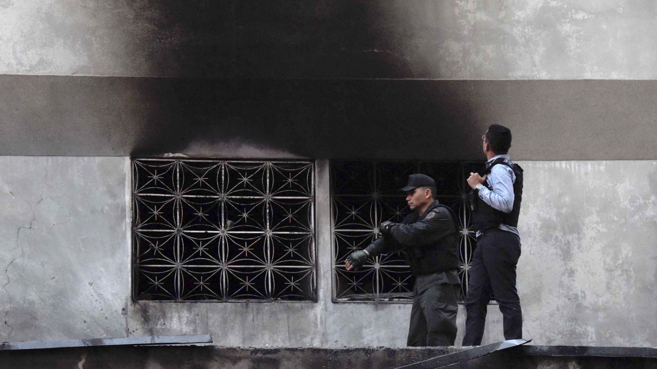 Security forces check a nearby building.