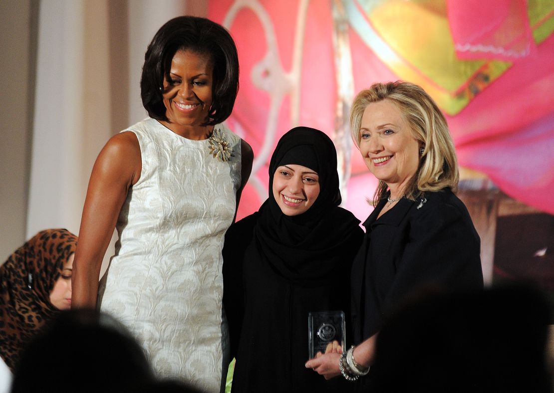Michelle Obama and Hillary Clinton pose with Samar Badawi as she receives the 2012 International Women of Courage Award.
