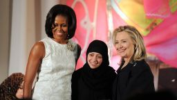 US First Lady Michelle Obama (L) and Secretary of State Hillary Clinton pose with Samar Badawi of Saudi Arabia as she receives the 2012 International Women of Courage Award during a ceremony at the US State Department in Washington, DC, on March 8, 2012. The prestigious Secretary of State's Award for International Women of Courage annually recognizes women around the globe who have shown exceptional courage and leadership in advocating for women's rights and empowerment, often at great personal risk. AFP Photo/Jewel Samad (Photo credit should read JEWEL SAMAD/AFP/Getty Images)