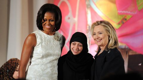 Former US First Lady Michelle Obama (left and Secretary of State Hillary Clinton pose with Samar Badawi of Saudi Arabia as she receives the 2012 International Women of Courage Award.