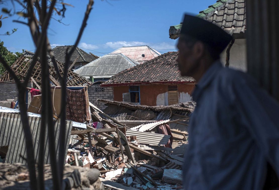 A man inspects the damage in Kayangan, on Lombok Island.