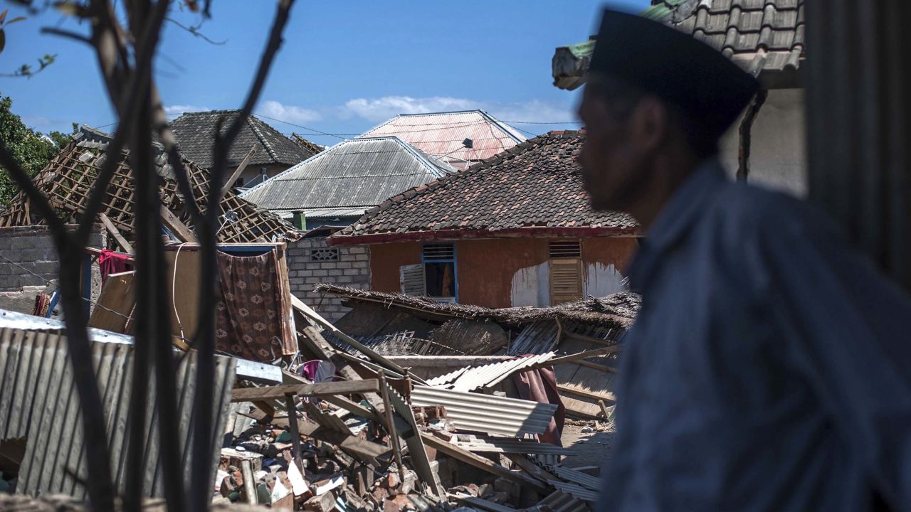 A man inspects the damage in Kayangan, on Lombok Island.