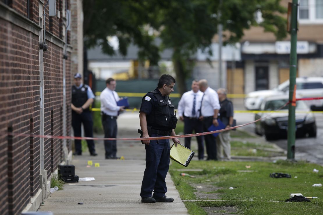 Chicago Police officers and detectives investigate a shooting where multiple people were shot on Sunday, August 5, 2018 in Chicago, Illinois. Over 30 people were shot and at least 2 killed across Chicago including five mass shootings, within 24 hours.