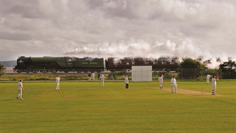 <strong>Railway recollections:</strong> Taliesin remembers "seeing steam trains for the first time on the Llangollen Railway" and "being taken to see one of the locomotives on the Ffestiniog Railway being named 'Taliesin.'" <em>Pictured here: A1 Trust No. 60163 Tornado passes a cricket match at Pwll</em>