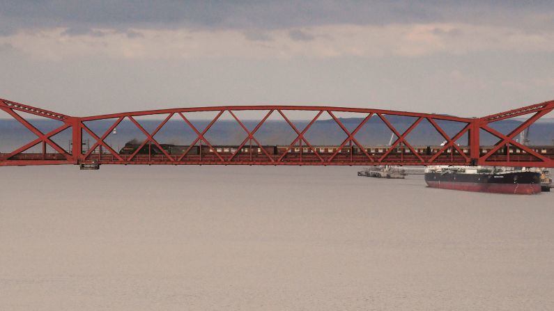 <strong>Bridge over water: </strong>This unusual picture shows a train speeding across Scotland's suspended Forth Rail Bridge: "The Forth Bridge is simply such an iconic location but capturing the essence of the suspended structure the vastness of the water under it is more difficult," says Robin of the image. <em>Pictured here: LNER A4 No. 60009 Union of South Africa crosses the Forth Bridge</em>