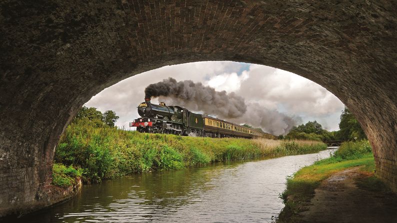 <strong>Train team</strong>: Father-and-son-team Robin and Taliesin Coombes travel across Britain capturing quirky photos of trains in the British landscape. <em>Pictured here: GWR Castle No. 5043 Earl of Mount Edgcumbe, Crofton</em>