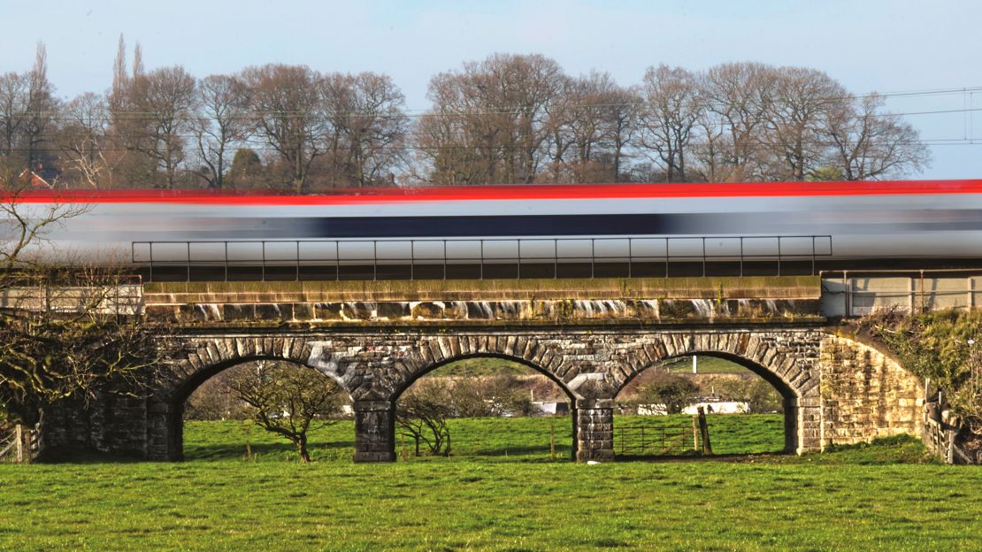 Pictured here: West Coast Flyer, Virgin Trains Class 390 Pendolino speeds past Little Haywood