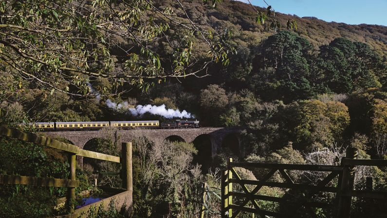 <strong>Other scenes: </strong>The pair's love of trains isn't going anywhere, but the photography duo do have pictures of other scenes. "We would also like to do a book of our non-railway photographs both portraits and landscape," says Robin. <em>Pictured here: BR(WR) Manor 7827 Lydham Manor crosses Greenway Viaduct, Paignton & Dartmouth Railway</em>