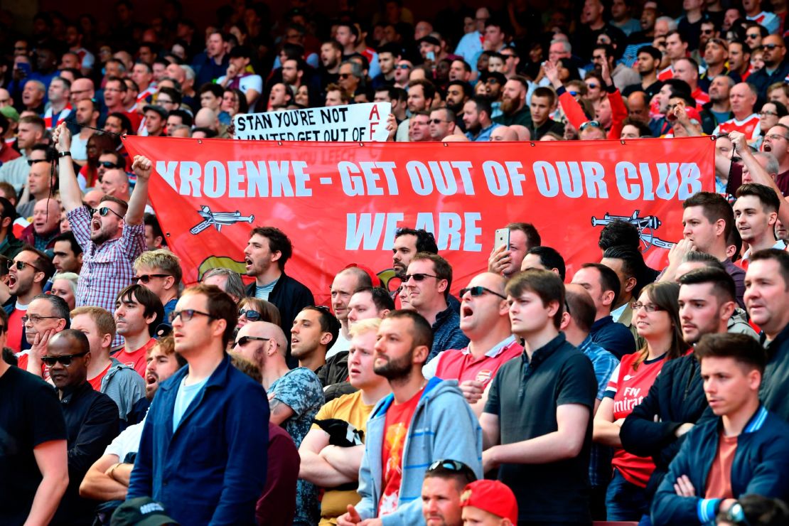 Arsenal fans hold up a banner against Arsenal's majority owner Stan Kroenke during the English Premier League football match between Arsenal and Everton on May 21, 2017.  