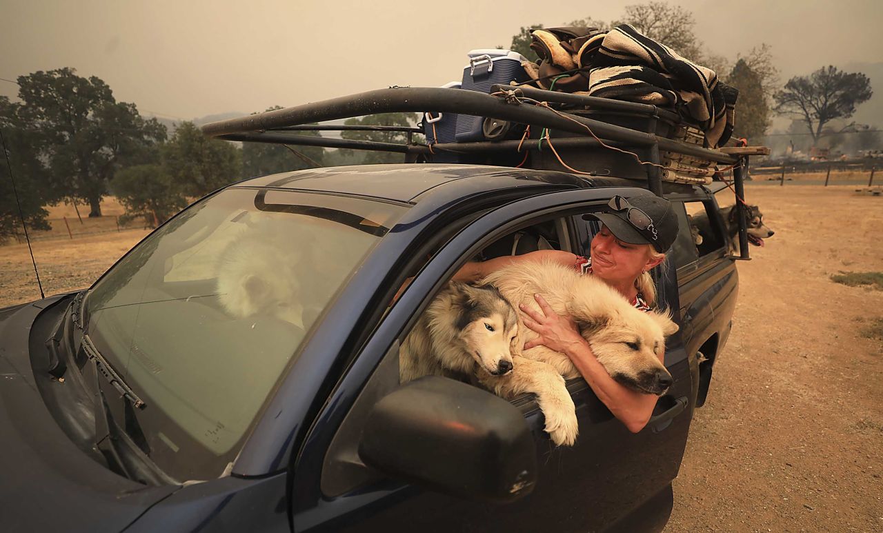 Crystal Easter comforts her dogs as they flee a wildfire in Spring Valley on Monday, August 6.