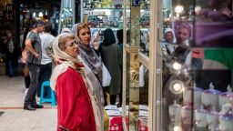 Customers browse goods on display in a store window inside the Grand Bazaar in Tehran, Iran, on Monday, Aug. 6, 2018. Irans central bank, acting on the eve of U.S. sanctions, scrapped most currency controls introduced this year in a bid to halt a plunge in the rial that has stirred protests against the government of President Hassan Rouhani. Photographer: Ali Mohammadi/Bloomberg via Getty Imagesrg