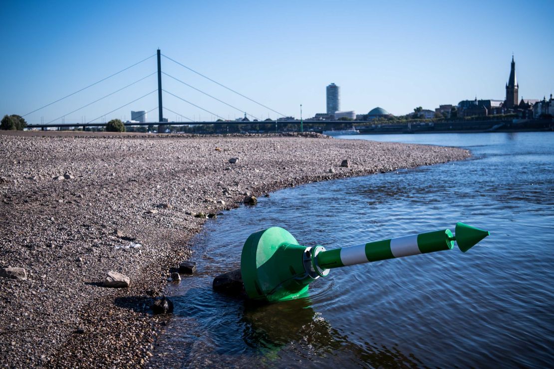 A buoy lies on the dry Rhine riverbed on a searing hot day in Dusseldorf, Germany, in August.