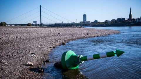 A buoy lies on the dry Rhine riverbed on a searing hot day in Dusseldorf, Germany, in August. 