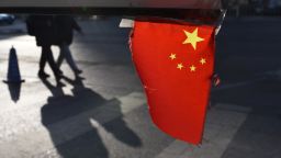 A Chinese national flag hangs from a barrier in a car park in Beijing on January 18, 2018.
China's economy grew a forecast-beating 6.9 percent in 2017, picking up steam for the first time since 2010 despite its battles against a massive debt and polluting factories, official data showed on January 18. / AFP PHOTO / Greg Baker        (Photo credit should read GREG BAKER/AFP/Getty Images)