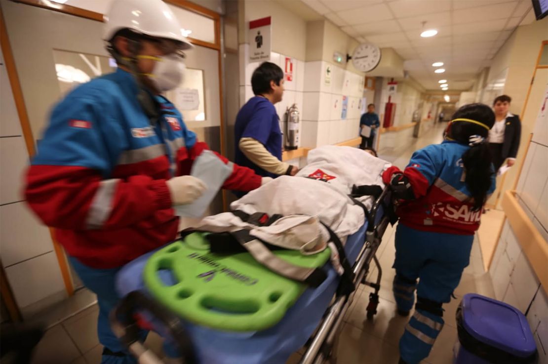 A young food-poisoning victim arrives to be treated at a hospital in Lima.
