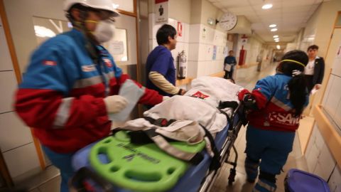 A young food-poisoning victim arrives to be treated at a hospital in Lima.