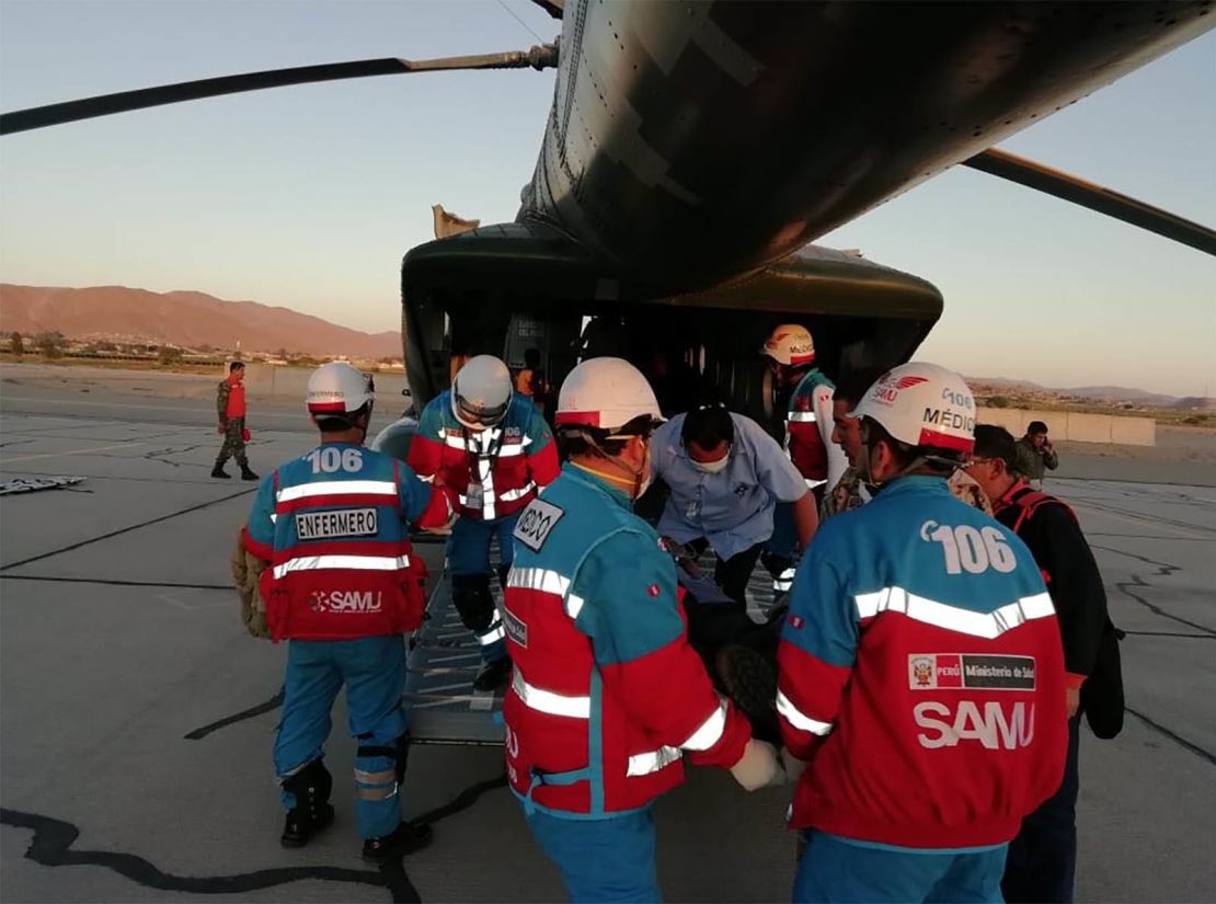Medics transport food-poisoning victims to a hospital in Lima.

