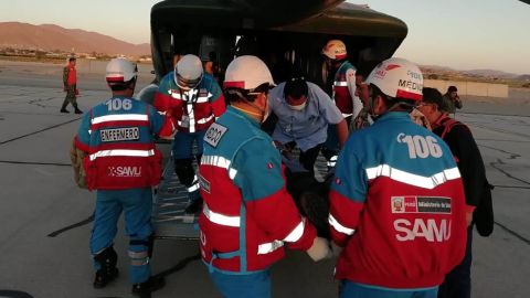 Medics transport food-poisoning victims to a hospital in Lima.
