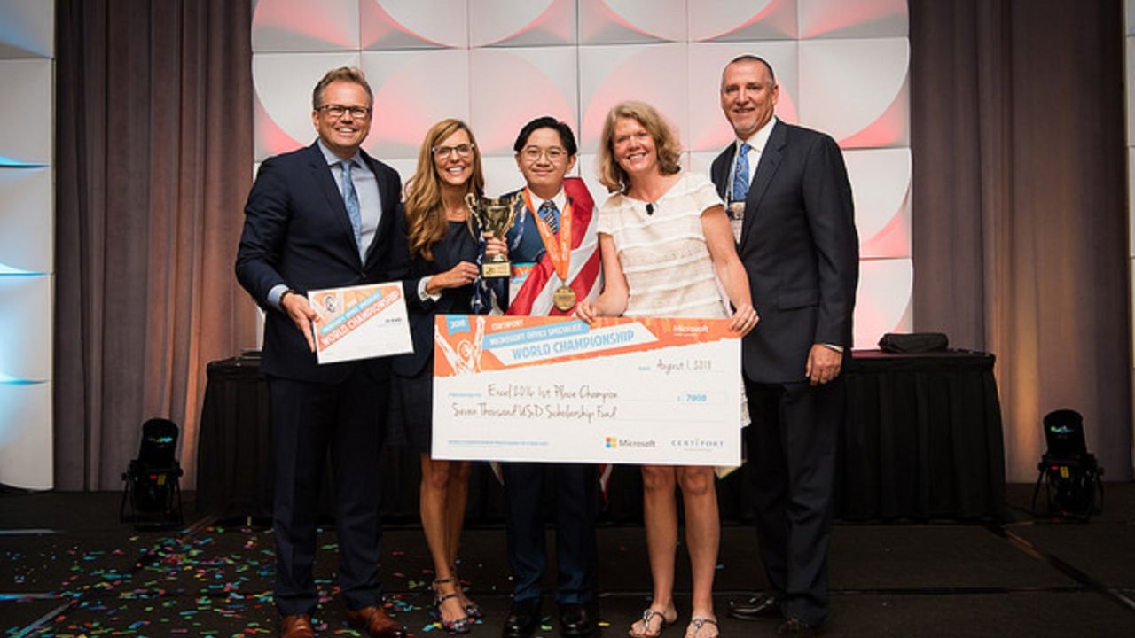 Kevin accepts his award after winning the Microsoft Excel championship.